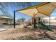 Community playground featuring slides, climbing structures, swings, and shaded picnic area at 13267 W Port Au Prince Ln, Surprise, AZ 85379