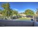 Scenic backyard view with lush trees and a view to the golf course from the second-story balcony at 13556 W Desert Flower Dr, Goodyear, AZ 85395