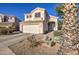 Charming two-story home with desert landscaping, attached two car garage, and neutral color palette at 13556 W Desert Flower Dr, Goodyear, AZ 85395