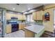 Functional kitchen featuring ample countertops, stainless steel appliances, and light wood cabinetry at 13556 W Desert Flower Dr, Goodyear, AZ 85395