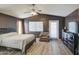 Main bedroom featuring a queen-sized bed, neutral tones, and a view to the backyard at 13556 W Desert Flower Dr, Goodyear, AZ 85395