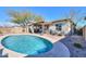 Inviting backyard pool with a covered patio and outdoor seating area, perfect for relaxation and entertaining at 139 E Desert Broom Dr, Chandler, AZ 85286