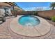 Lush backyard featuring a refreshing pool, brick patio, and outdoor grill area perfect for outdoor entertaining at 139 E Desert Broom Dr, Chandler, AZ 85286