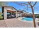 Beautiful backyard showcasing a pool, covered patio, and stylish outdoor furniture under a clear blue sky at 139 E Desert Broom Dr, Chandler, AZ 85286