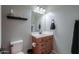 Neutral bathroom featuring a sink vanity, a framed mirror, and a toilet at 139 E Desert Broom Dr, Chandler, AZ 85286