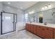 Modern bathroom with a glass shower, soaking tub, double vanity, and ample counter space for comfort at 139 E Desert Broom Dr, Chandler, AZ 85286