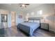 Relaxing bedroom with a comfortable queen-size bed, wood-look flooring, and natural light at 139 E Desert Broom Dr, Chandler, AZ 85286