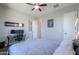 Comfortable bedroom with a ceiling fan, nice decor, and a workspace with a desk at 139 E Desert Broom Dr, Chandler, AZ 85286