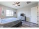 Inviting bedroom featuring neutral colors, a ceiling fan, and a stylish dresser with a mounted television at 139 E Desert Broom Dr, Chandler, AZ 85286