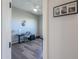 A glimpse of bedroom with hardwood floors, ceiling fan, a desk, and decor at 139 E Desert Broom Dr, Chandler, AZ 85286