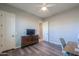 Bedroom featuring a dresser, ceiling fan, multiple doors and windows, and wood flooring at 139 E Desert Broom Dr, Chandler, AZ 85286