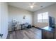 Bedroom with a ceiling fan, laminate wood floors, a window and a desk setup at 139 E Desert Broom Dr, Chandler, AZ 85286