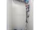 A closet with a Dyson vacuum cleaner hanging on the wall for convenient storage at 139 E Desert Broom Dr, Chandler, AZ 85286