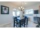 Cozy dining area with a view of the backyard, featuring a stylish chandelier and a dining table at 139 E Desert Broom Dr, Chandler, AZ 85286