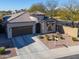 Well-manicured home featuring desert landscaping, a tile roof, and a two-car garage on a sunny day at 139 E Desert Broom Dr, Chandler, AZ 85286