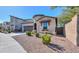 Charming home exterior with desert landscaping, a two-car garage, and unique architectural details at 139 E Desert Broom Dr, Chandler, AZ 85286