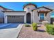 Attractive home featuring desert landscaping, a two-car garage, and a stylish arched entryway at 139 E Desert Broom Dr, Chandler, AZ 85286