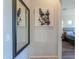 Hallway with modern art and a mirror leads to a serene bedroom with contemporary furnishings at 139 E Desert Broom Dr, Chandler, AZ 85286