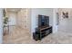 Bright hallway featuring stylish tiled floors, multiple doors, and a modern TV setup on a sleek console at 139 E Desert Broom Dr, Chandler, AZ 85286