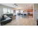 Bright, open-concept living room flowing into modern kitchen and dining area with natural light from large windows at 139 E Desert Broom Dr, Chandler, AZ 85286