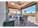 Inviting covered patio with outdoor dining area, ceiling fan, and views of the pool at 139 E Desert Broom Dr, Chandler, AZ 85286