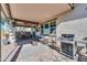 Relaxing covered patio with a seating area, BBQ, ceiling fan, and outdoor speakers at 139 E Desert Broom Dr, Chandler, AZ 85286