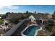 Aerial view of a backyard oasis with a sparkling pool, patio, and lush lawn at 1431 S Nielson St, Gilbert, AZ 85296