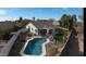 Aerial view of a backyard oasis with a sparkling pool, patio, and lush lawn at 1431 S Nielson St, Gilbert, AZ 85296