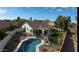 Aerial view of a backyard oasis with a sparkling pool, patio, and lush lawn at 1431 S Nielson St, Gilbert, AZ 85296