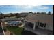 Aerial view of a backyard oasis with a sparkling pool, patio, and lush lawn at 1431 S Nielson St, Gilbert, AZ 85296