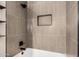 Modern bathroom featuring tiled shower with black hardware and recessed shelf at 1431 S Nielson St, Gilbert, AZ 85296