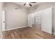 Bedroom with neutral walls, wood-style tile flooring, and a view to an adjacent room at 1431 S Nielson St, Gilbert, AZ 85296