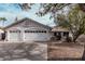 Charming one-story home featuring a two car garage, desert landscaping, and neutral colored stucco at 1431 S Nielson St, Gilbert, AZ 85296