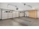 Spacious three-car garage with epoxy floor, storage cabinets, and two overhead doors at 1431 S Nielson St, Gilbert, AZ 85296