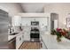 Bright kitchen with white cabinets, stainless steel appliances, and quartz countertops at 1431 S Nielson St, Gilbert, AZ 85296