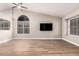 Bright living room featuring wood tile flooring and a ceiling fan at 1431 S Nielson St, Gilbert, AZ 85296