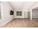 Neutral living room with wood tile flooring, TV, and front door at 1431 S Nielson St, Gilbert, AZ 85296