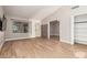 Spacious living room with wood-look flooring, lots of natural light, and neutral-colored walls at 1431 S Nielson St, Gilbert, AZ 85296