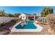 Private backyard with a sparkling pool, desert landscaping and covered patio at 1431 S Nielson St, Gilbert, AZ 85296