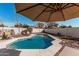 Sparkling swimming pool surrounded by patio and lush landscaping at 1431 S Nielson St, Gilbert, AZ 85296