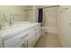 Bright bathroom featuring double sinks with quartz countertops and modern fixtures at 14334 W Avalon Dr, Goodyear, AZ 85395