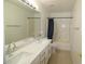 Bathroom with dual sinks, a large mirror, and a shower-tub combo at 14334 W Avalon Dr, Goodyear, AZ 85395