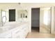 Bathroom features a double sink vanity and a separate area containing a shower and tub at 14334 W Avalon Dr, Goodyear, AZ 85395