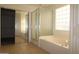 Bathroom boasts a soaking tub, glass shower enclosure, and a separate toilet area for added privacy at 14334 W Avalon Dr, Goodyear, AZ 85395