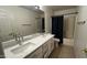 Bathroom featuring dual vanity, large mirror, and a shower/tub combo at 14334 W Avalon Dr, Goodyear, AZ 85395