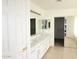 Bathroom boasts a double sink vanity, ample storage, and access to a shower and walk-in closet at 14334 W Avalon Dr, Goodyear, AZ 85395