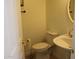 Powder room featuring neutral tile floors, a pedestal sink, toilet and window for natural light at 14334 W Avalon Dr, Goodyear, AZ 85395