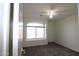 Spacious bedroom featuring plush carpeting, a ceiling fan, and a bright window at 14334 W Avalon Dr, Goodyear, AZ 85395