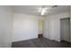 Bedroom with a ceiling fan, plush carpet, and closet space at 14334 W Avalon Dr, Goodyear, AZ 85395