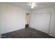 Bedroom boasts neutral walls, a ceiling fan, and a sliding-door closet for storage at 14334 W Avalon Dr, Goodyear, AZ 85395